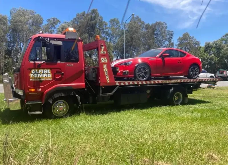 Brand New Red Car is Being Transported — Alpine Towing Services in Lismore, NSW