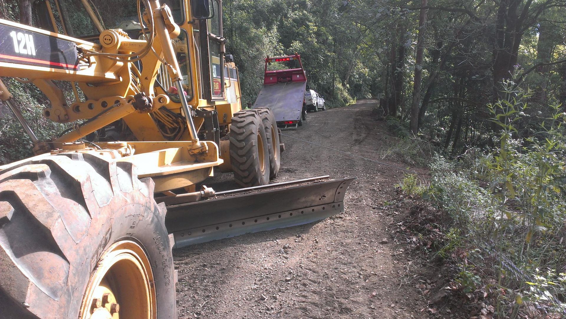 An Agricultural Machine Being Towed Up Hill— Alpine Towing Services in Ballina, NSW