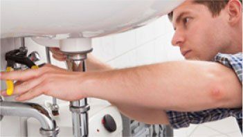 Technician Fixing the Lavatory Drain — Ogden, UT — Mike Bachman Plumbing