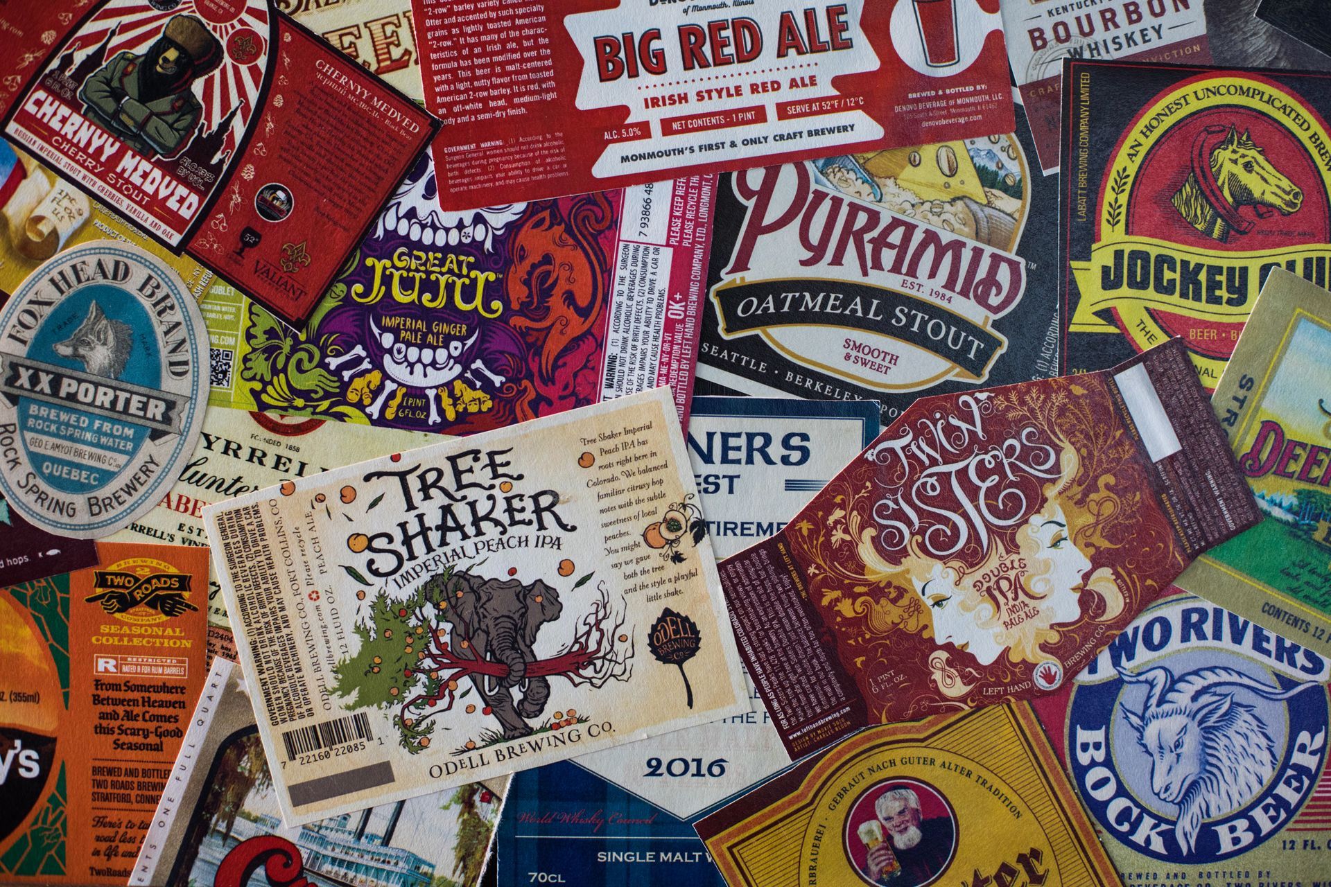 Close-up of assorted beer labels with different designs and colors.