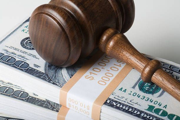 Judge gavel on top of dollar bills | Bail Bonds in Waxhaw NC. 