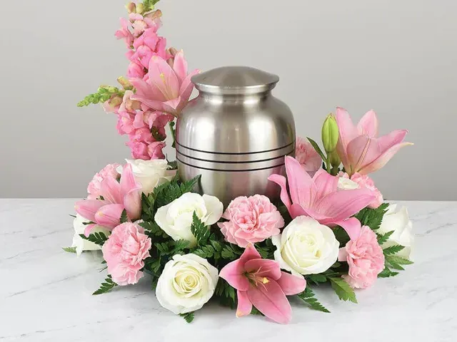 A cluster of white tulips with green stems and leaves, viewed from above.