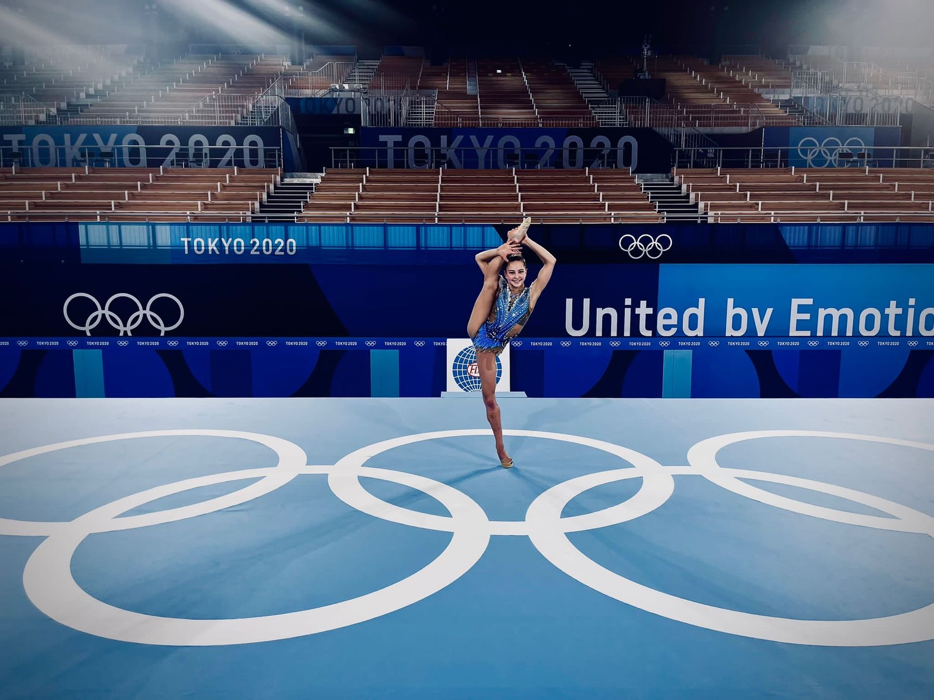 A woman wearing a purple polo shirt is smiling for the camera.