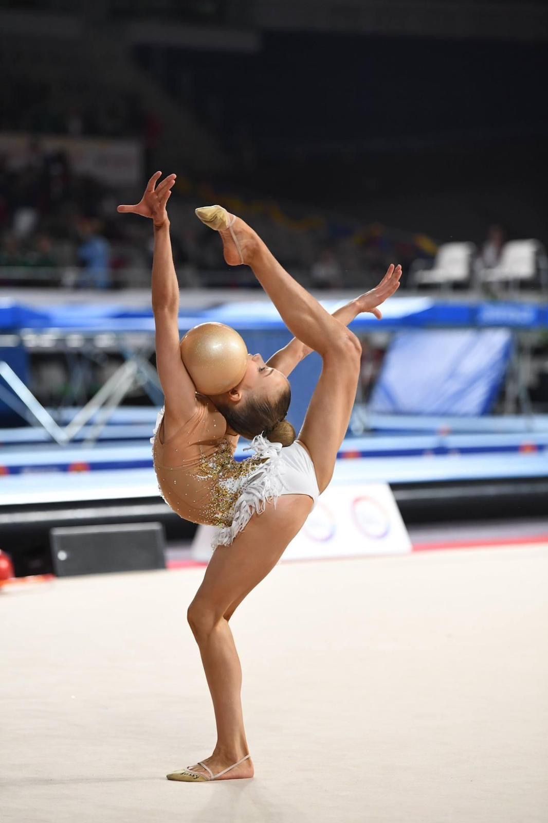 A woman in a purple shirt is smiling for the camera.