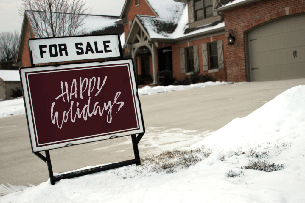 A for sale sign with happy holidays written on it