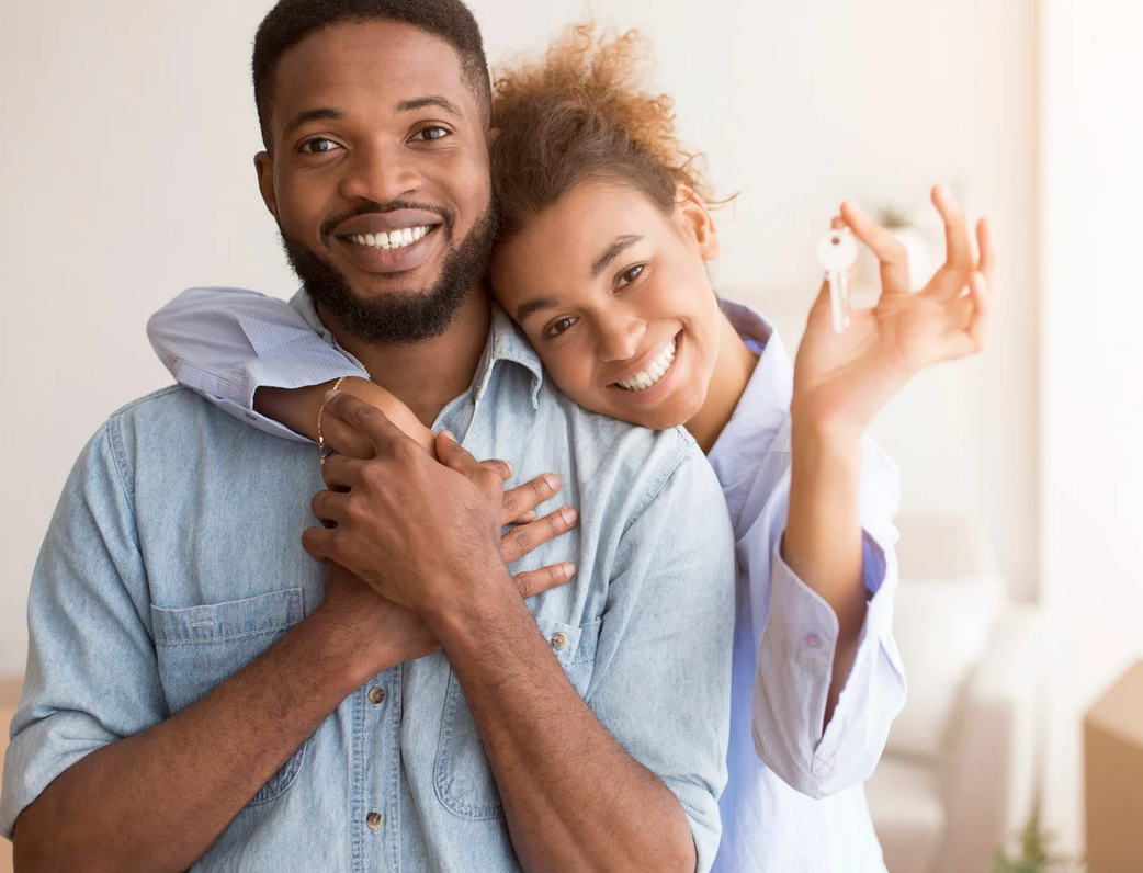 Happy couple holding keys to their new Members Credit Union home loan