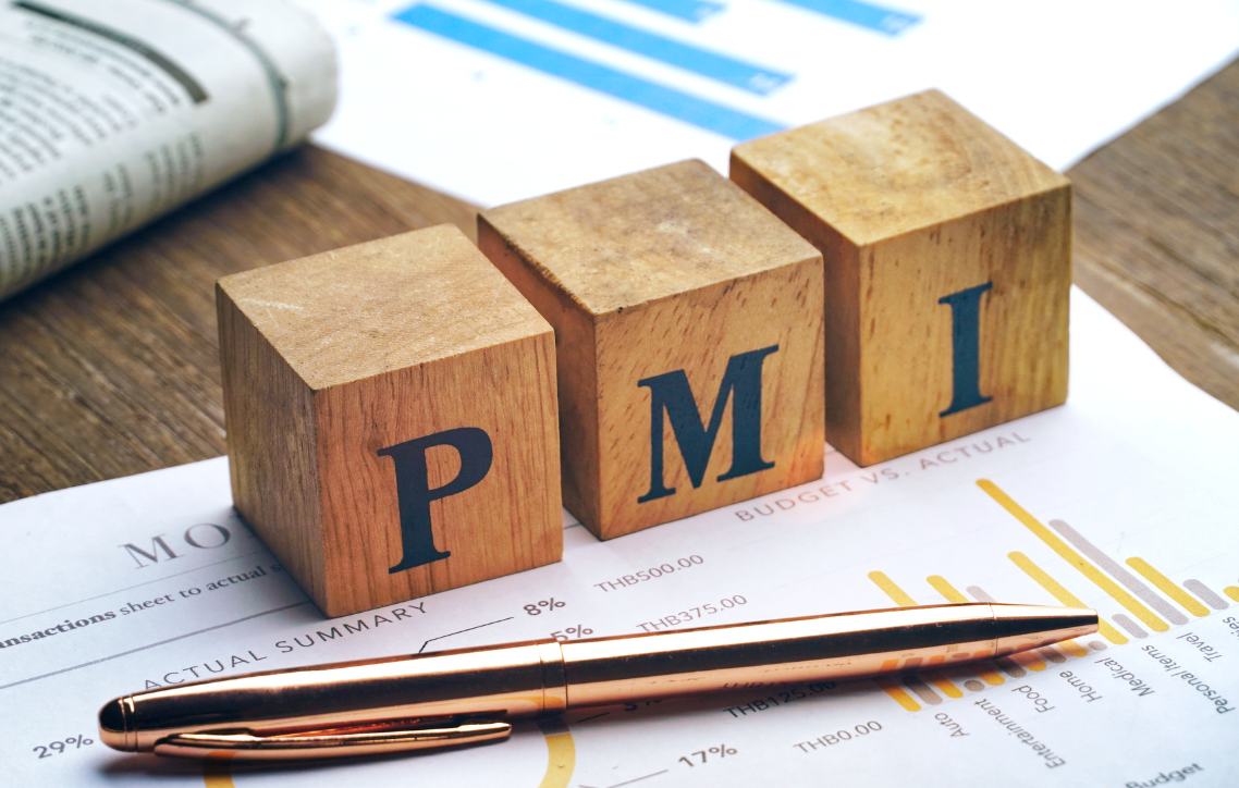 Wooden PMI blocks on a financial report with a pen and charts in the background