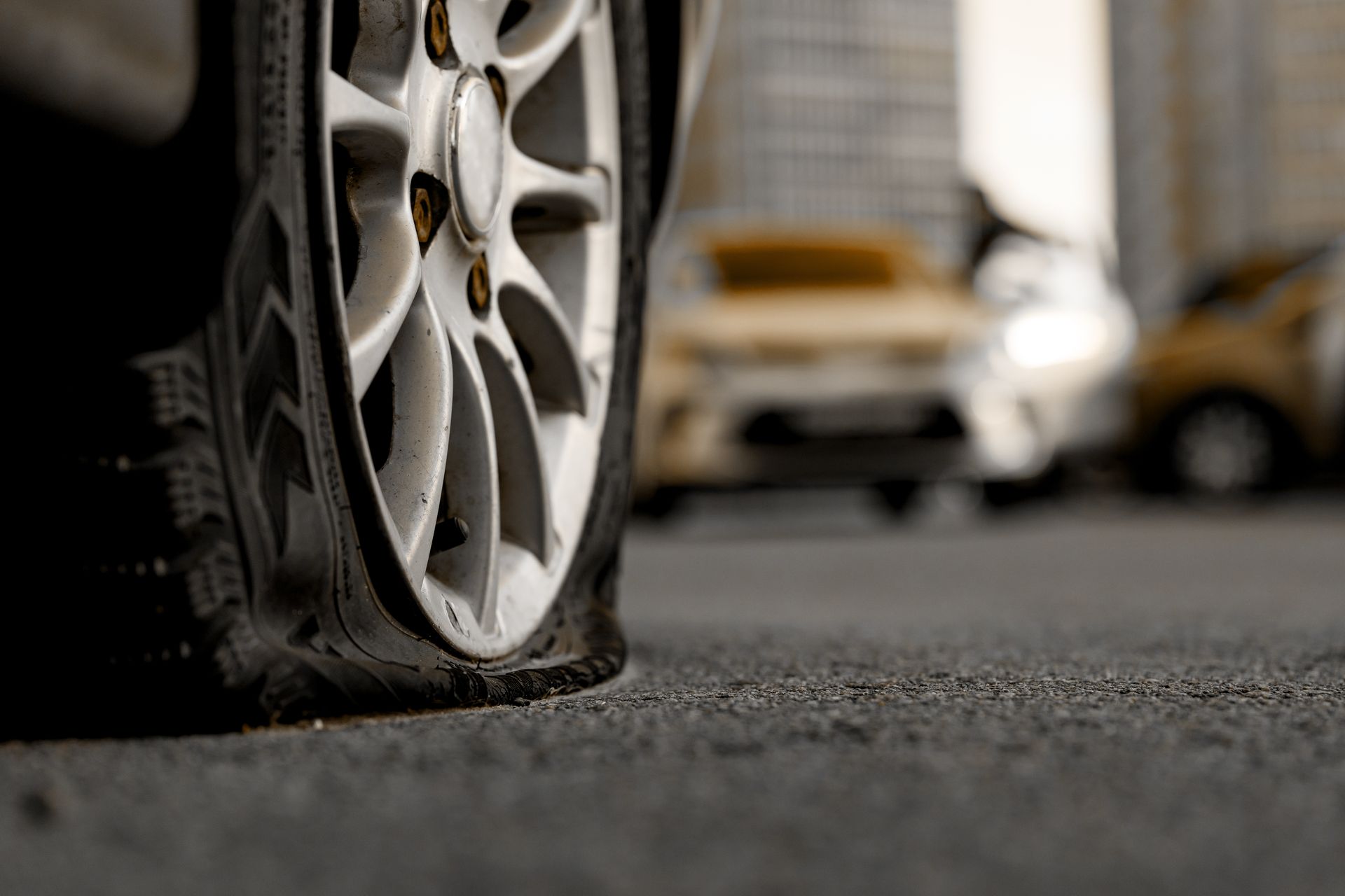 A close up of a flat tire on the side of a road | Beachview Auto Service