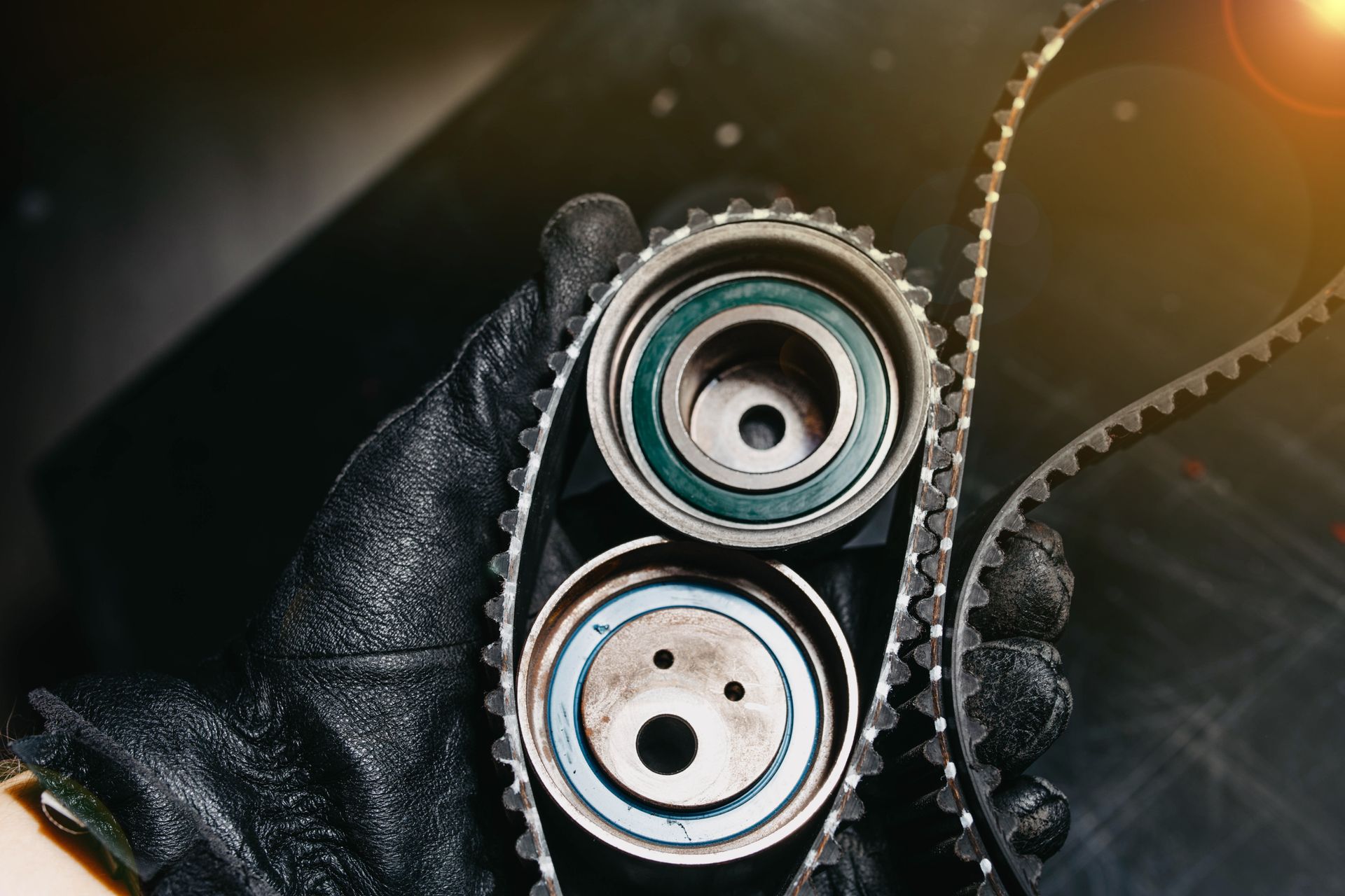 A person is holding a timing belt in their hand | Beachview Auto Service