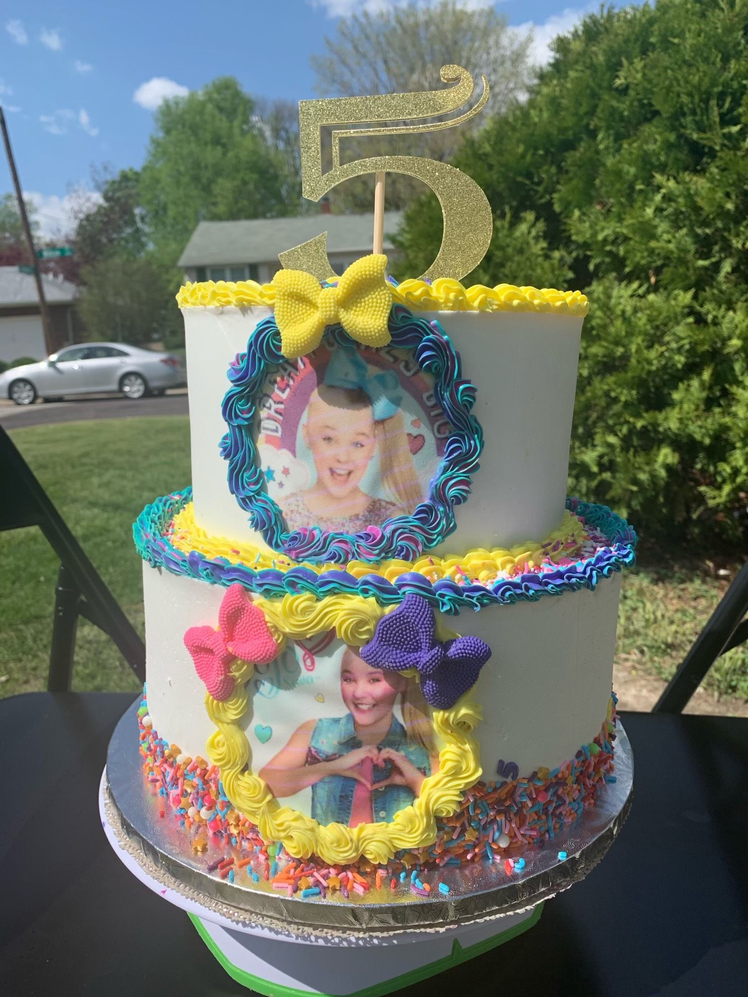 A birthday cake with a picture of jojo siwa on it is sitting on a table.