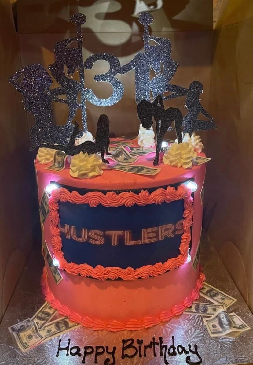 A pink birthday cake with the word hustlers on it