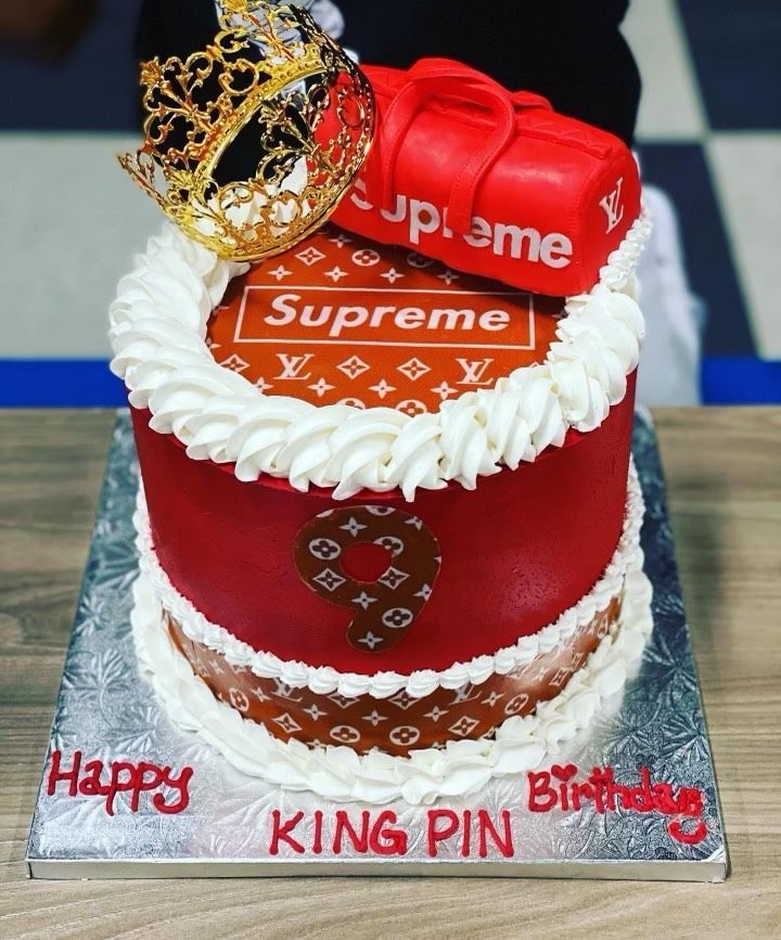 A supreme cake with a crown and a bag on top