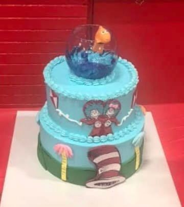 A cake with a cat in the hat on top of it.