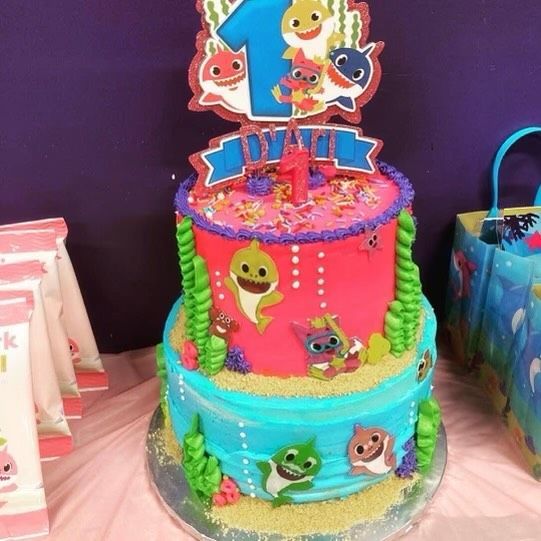 A pink and blue cake with the number 1 on top