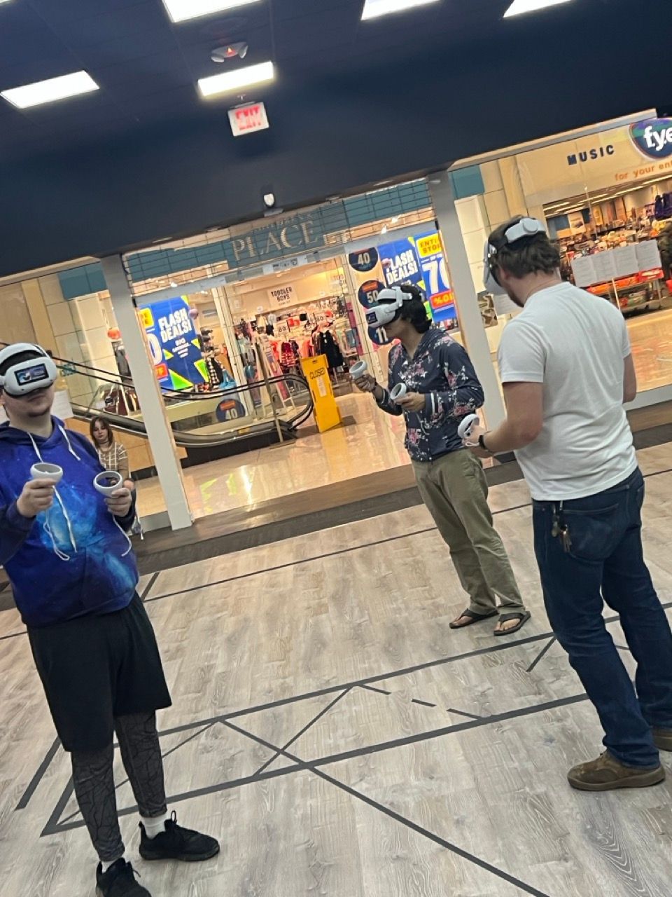 A group of people wearing virtual reality headsets in a store.