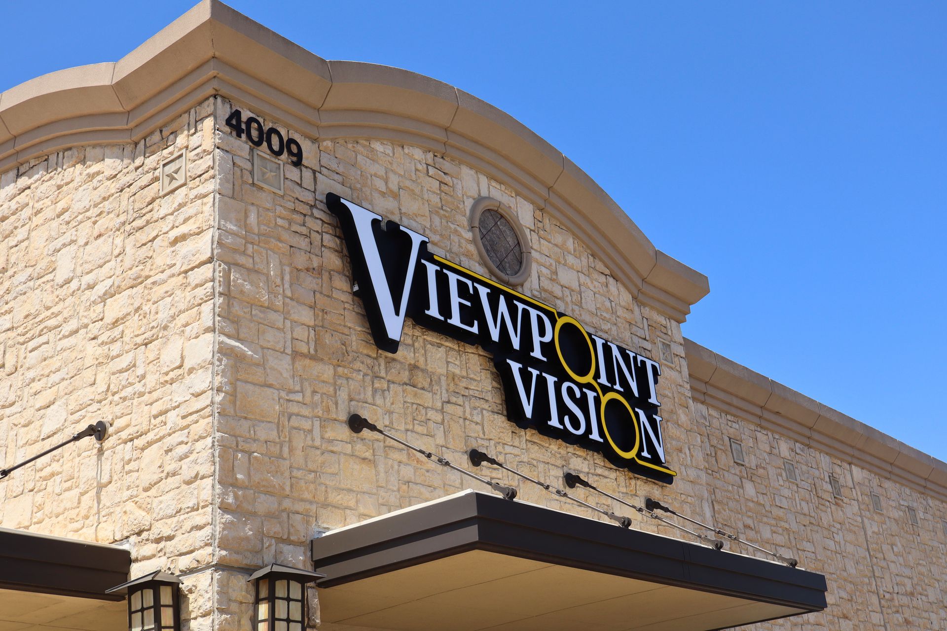 A viewpoint vision store front with a blue sky in the background