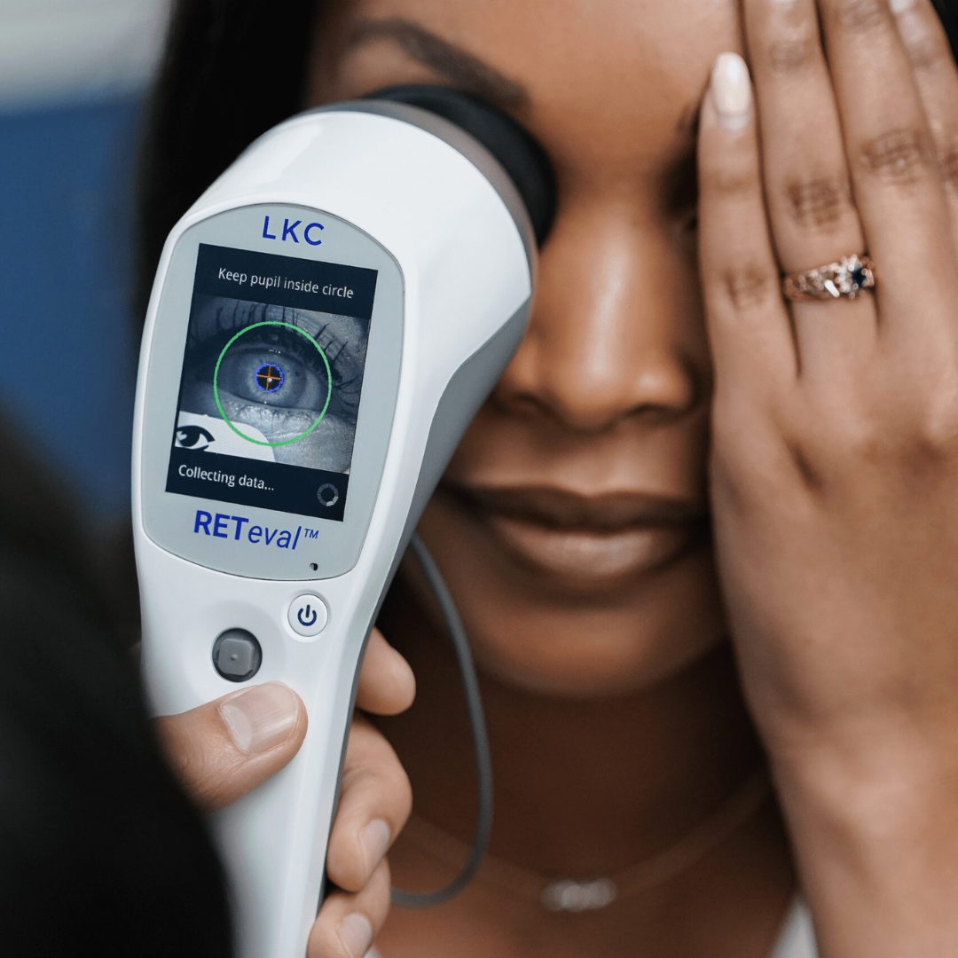 A woman is holding a device that says lkc on it