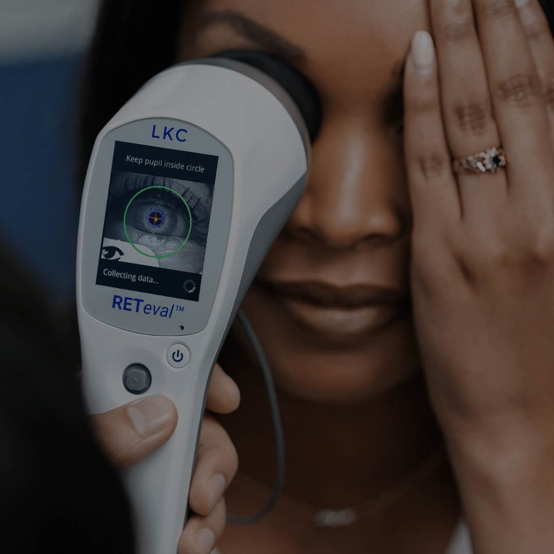 A woman is holding a device that says lkc on it