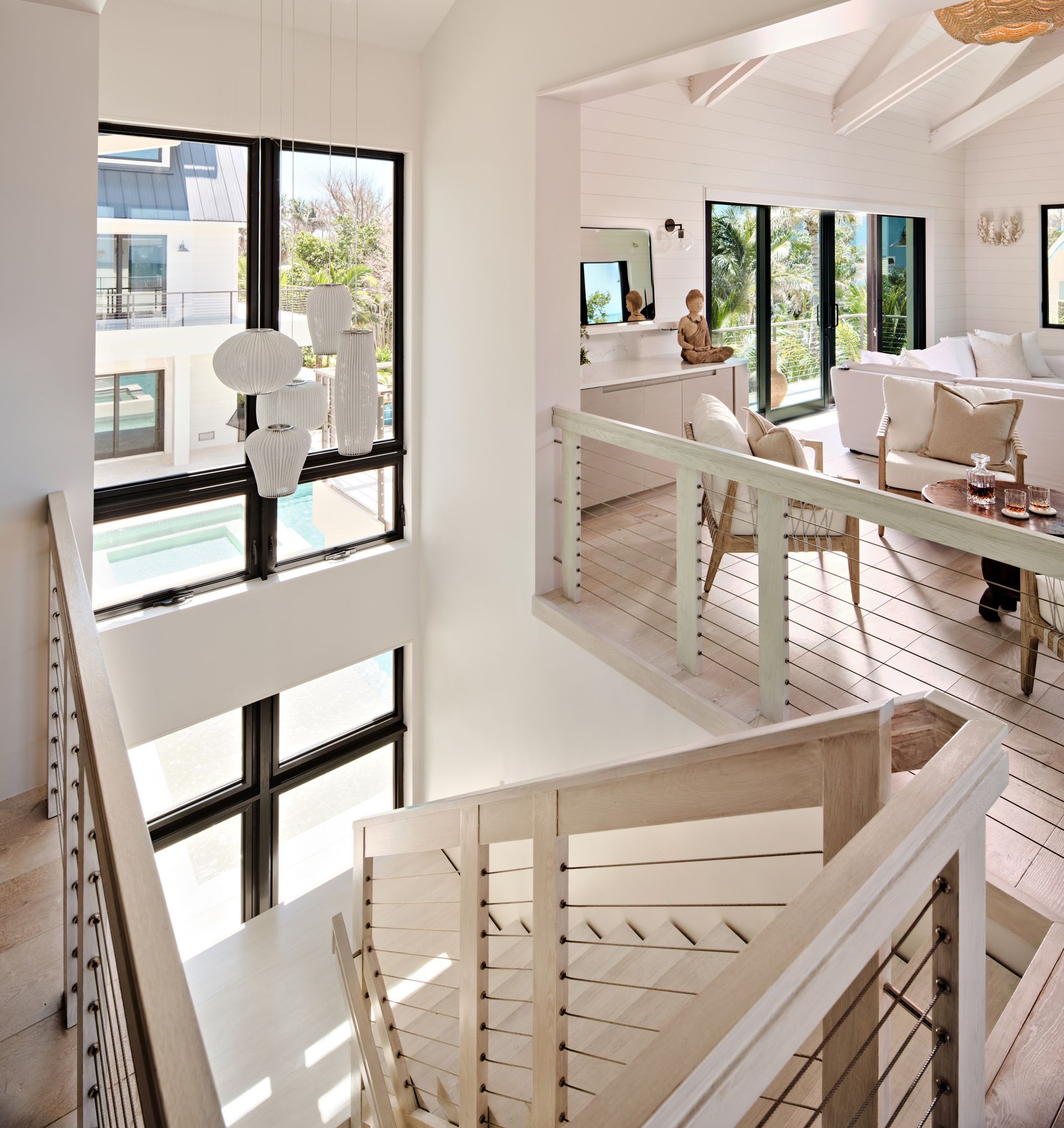 a large white house sits in the middle of a lush green  lawn