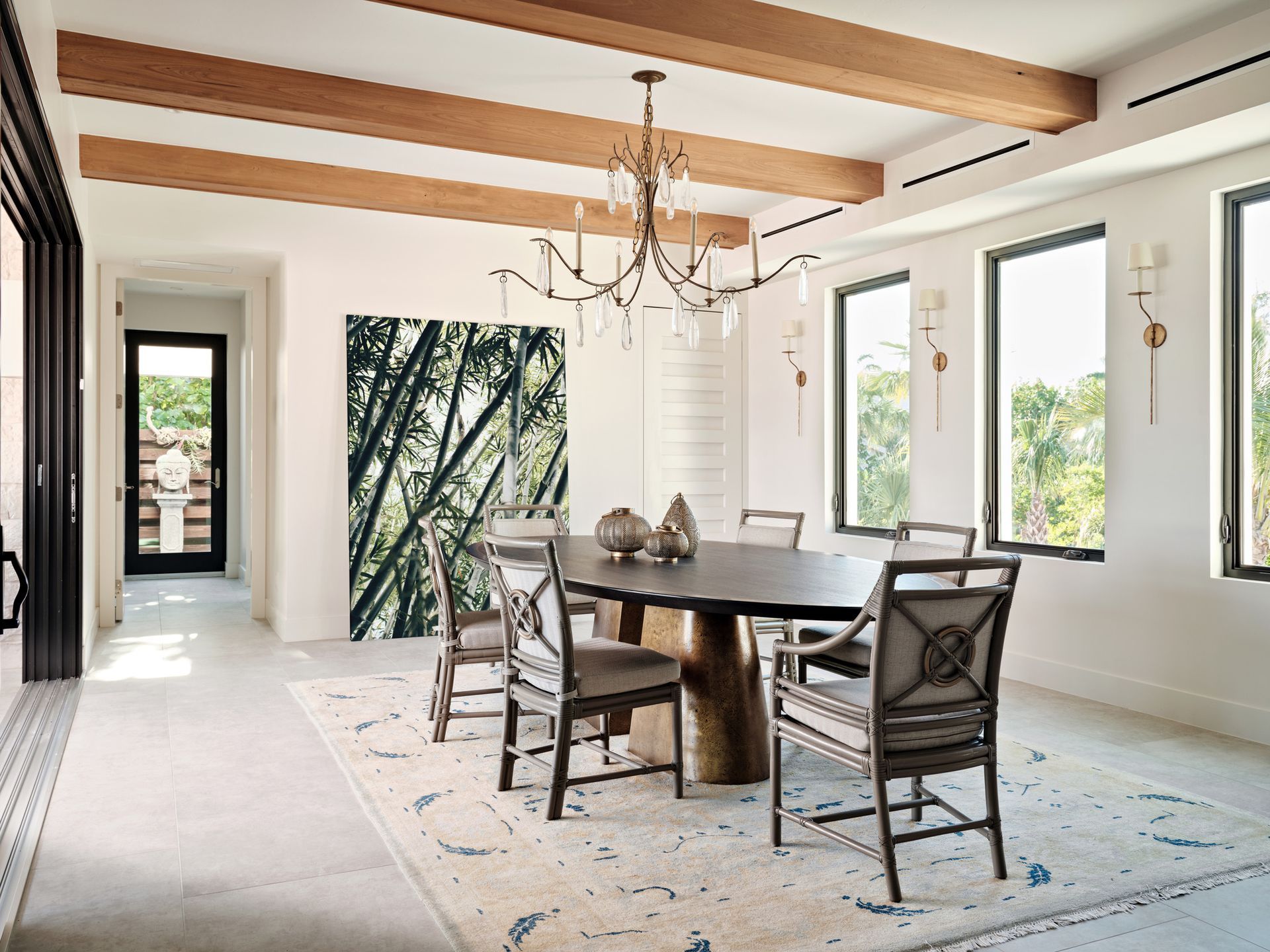 A dining room with a table and chairs and a chandelier.