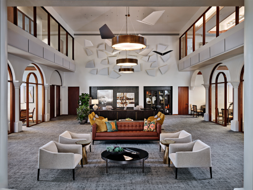 A living room with a couch and chairs in it