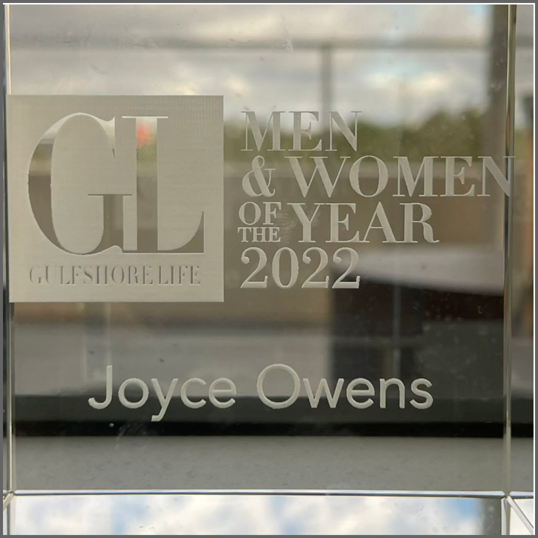 A glass block with the name joyce owens on it -Architecture Joyce Owens