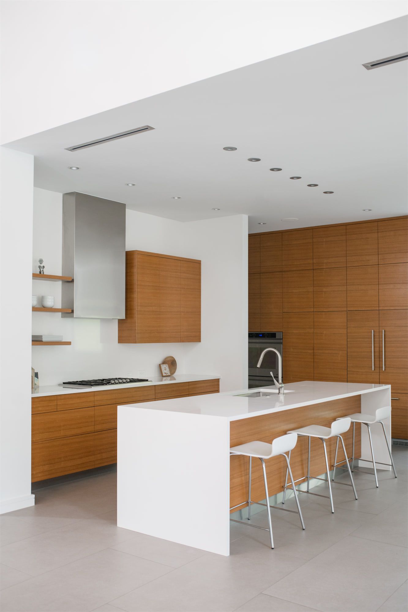 a kitchen with wooden cabinets and white counter tops
