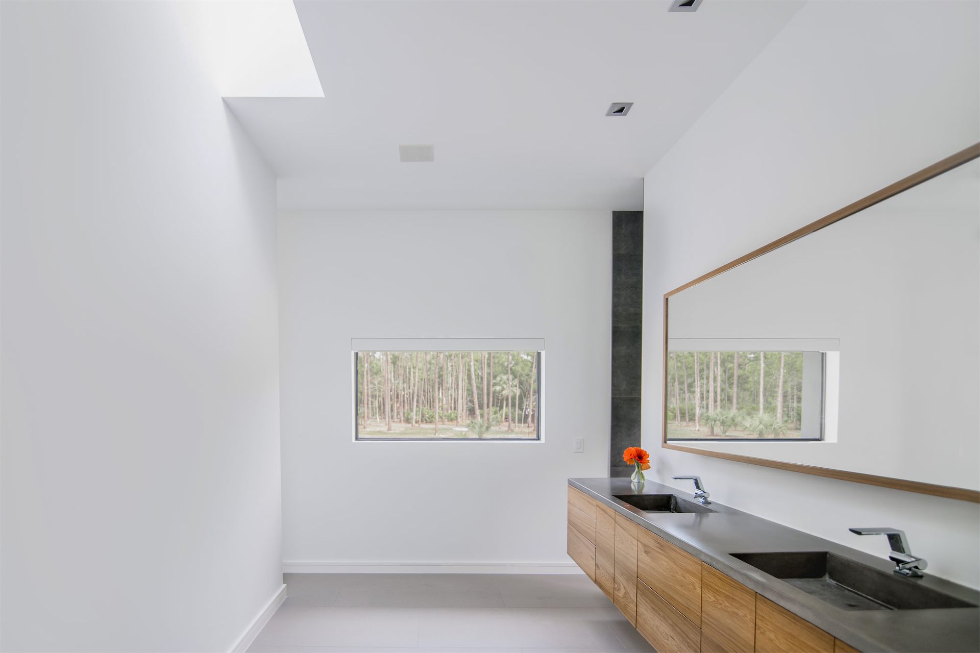 a bathroom with two sinks and a large mirror