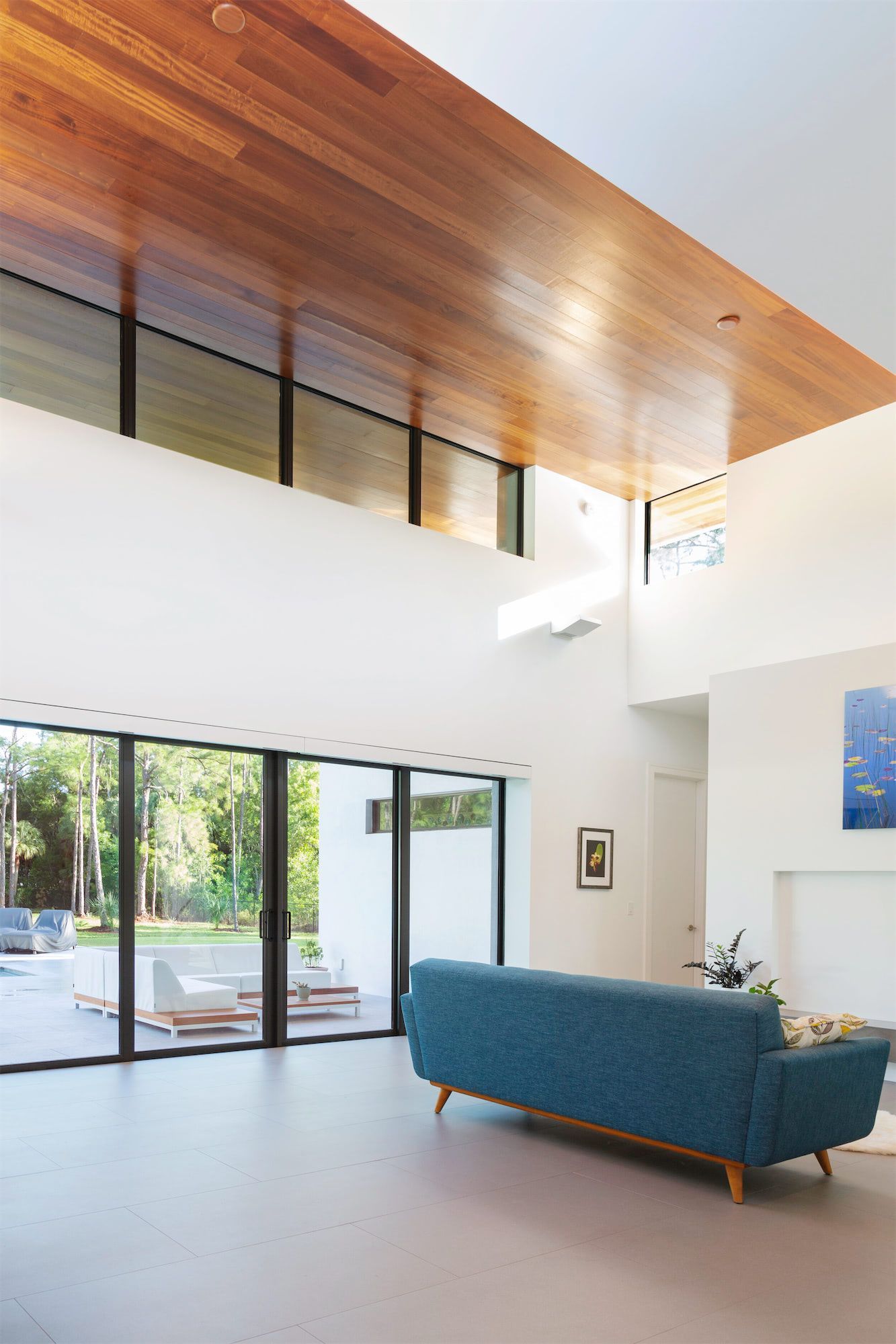 a living room with a blue couch and sliding glass doors