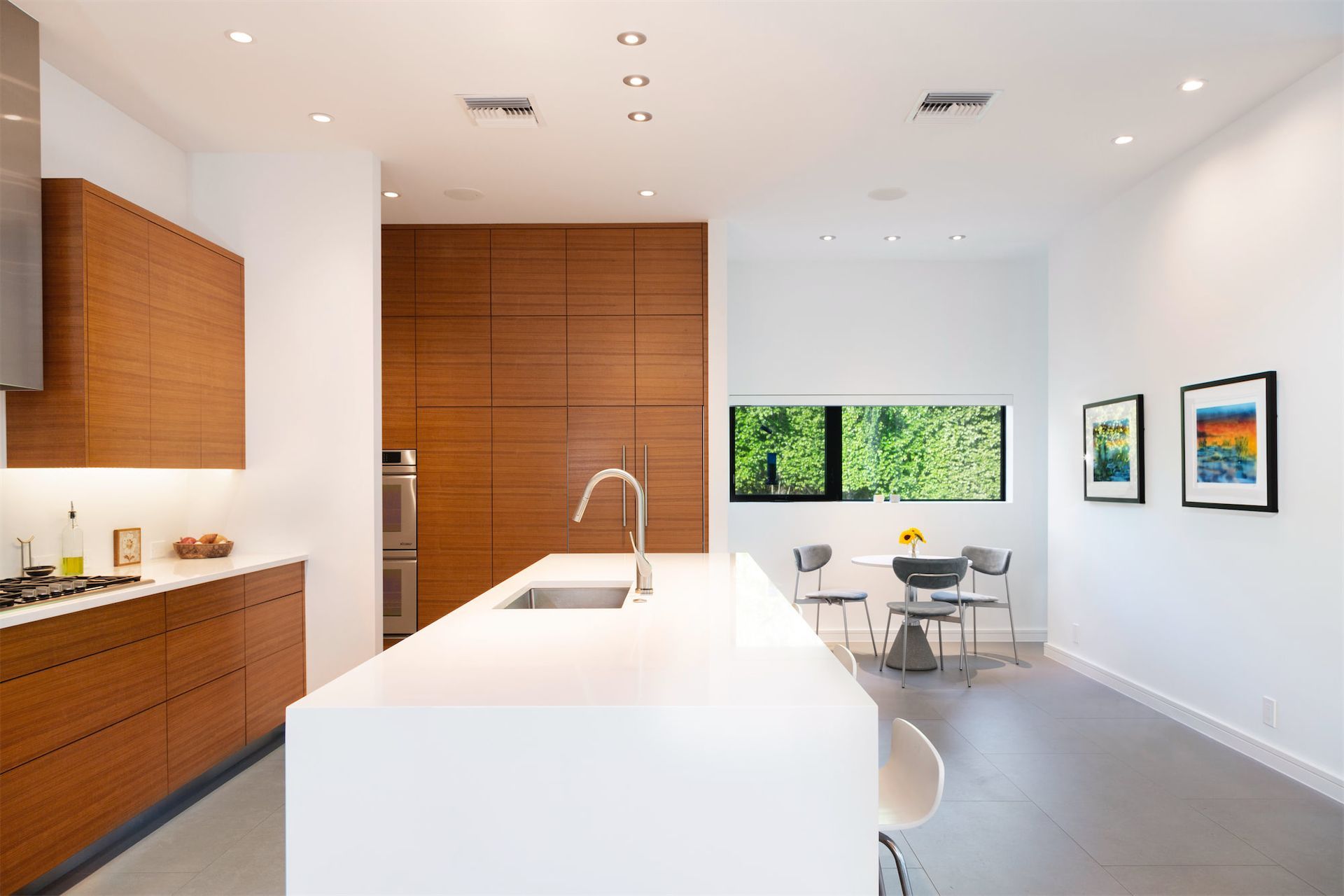 a kitchen with wooden cabinets and white counter tops