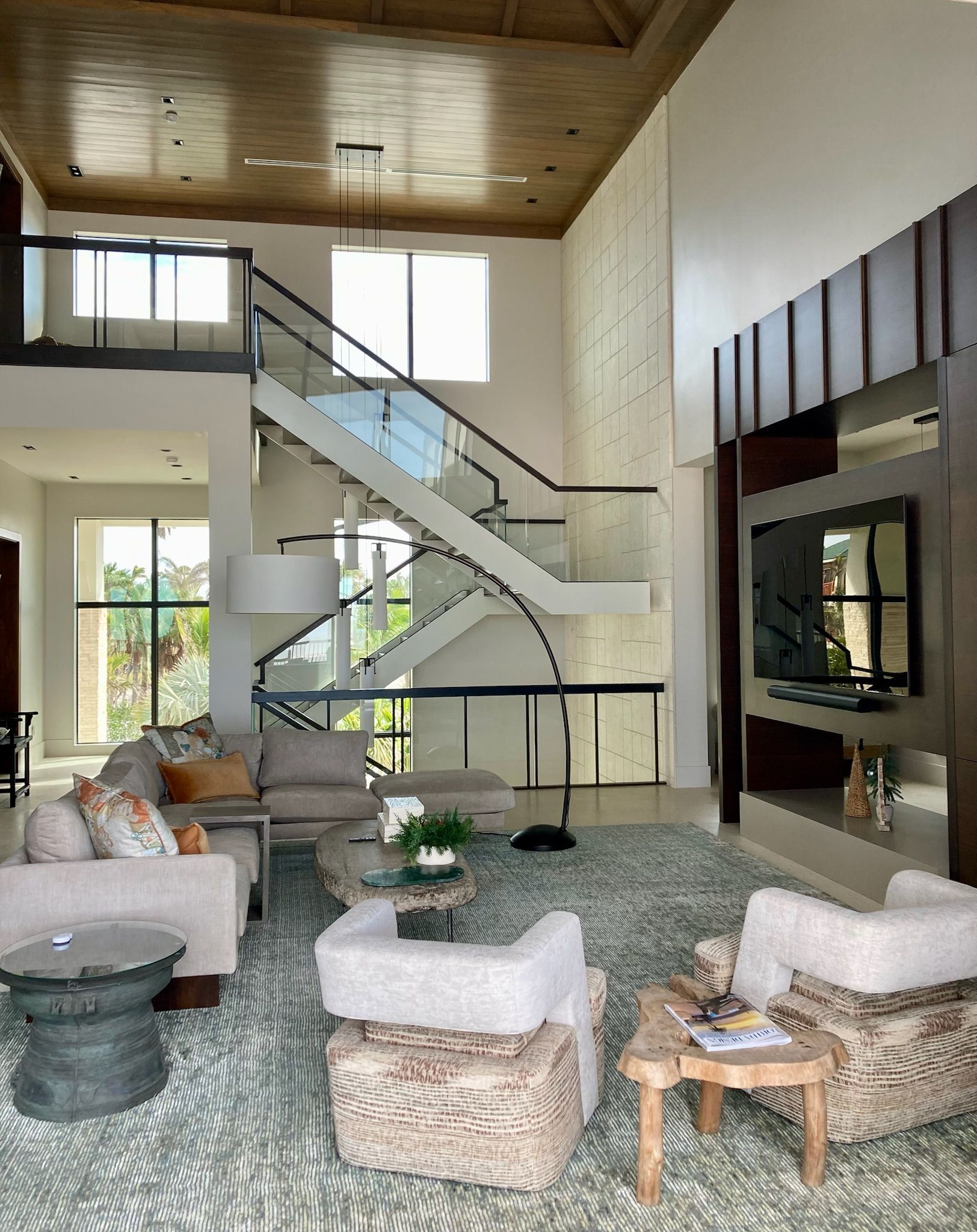 A living room with a staircase and a lot of furniture