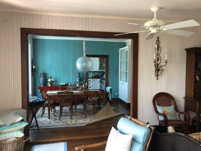a small dining room with a dark wooden table and chairs and a globe chandelier light
