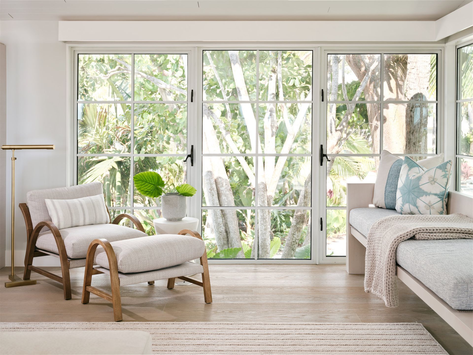 a chair and ottoman sit in front of a sliding glass door