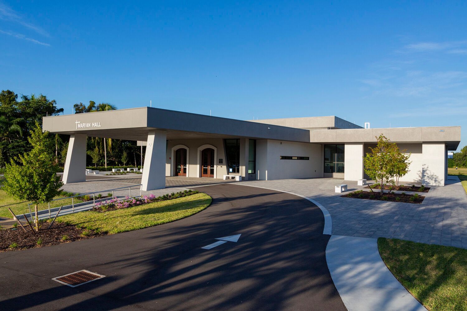 exterior of a gray modern church with driveway