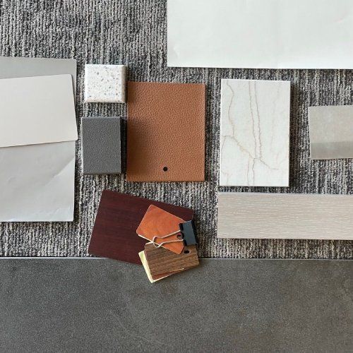 A bunch of different types of tiles and papers are sitting on a table.
