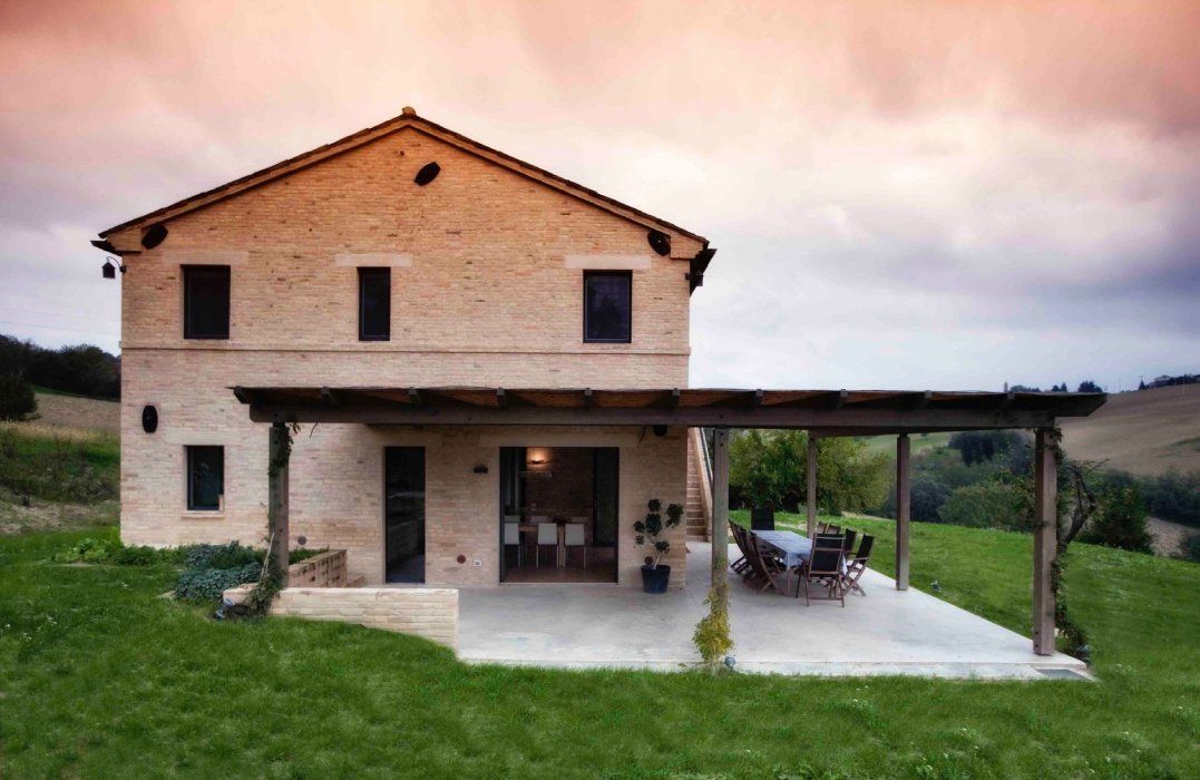 a large white house sits in the middle of a lush green  lawn