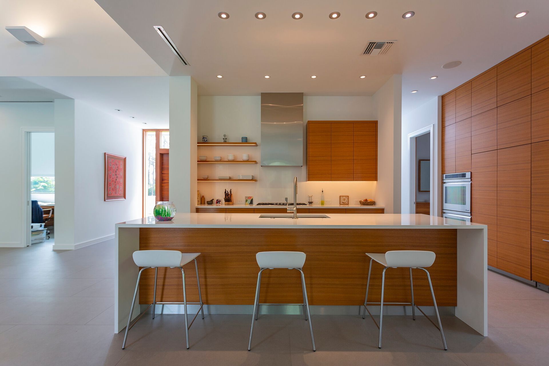 a kitchen with wooden cabinets and white counter tops