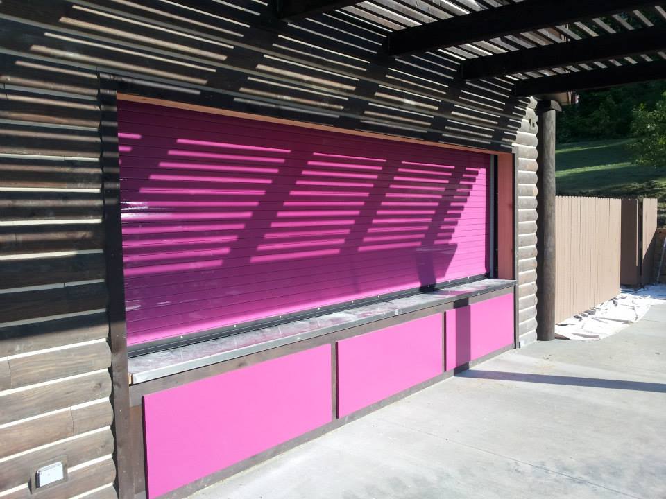 A building with pink cabinets and shutters on it