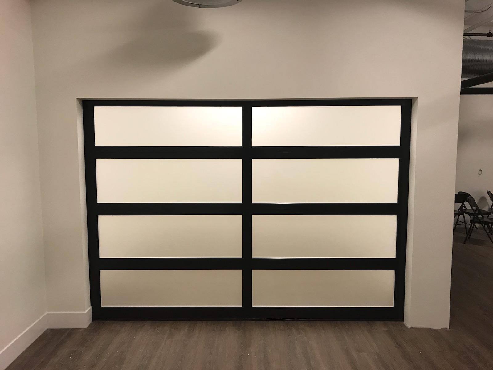 A room with a sliding glass door and a wooden floor.