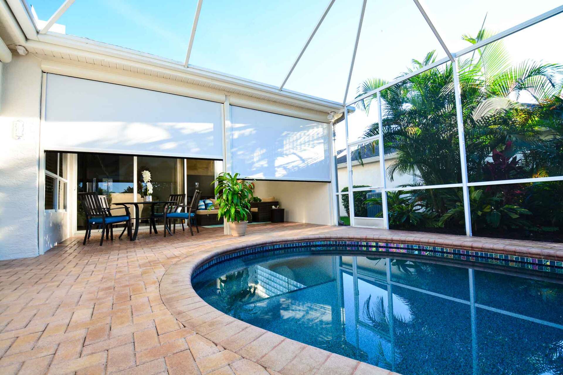 A large swimming pool in the backyard of a house