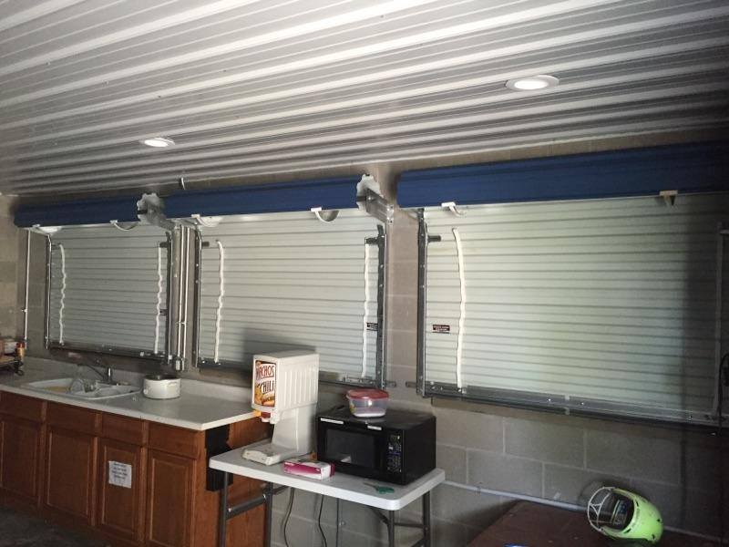 A kitchen with a microwave , sink , and a table.