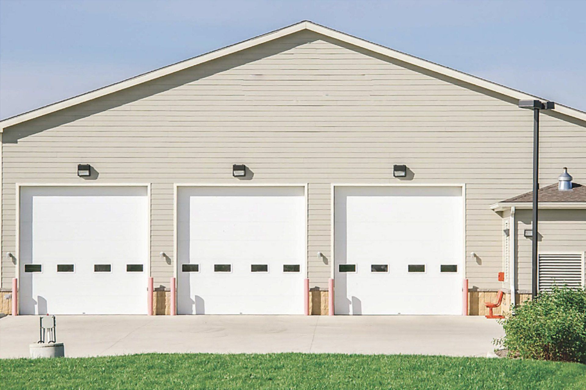 A large building with a lot of white garage doors