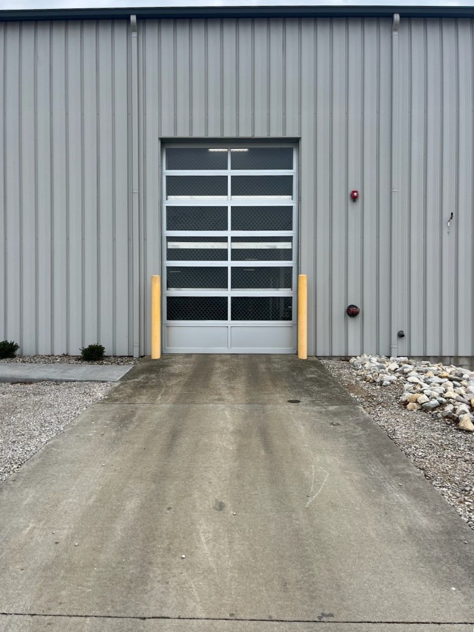 A garage door with a concrete driveway leading to it