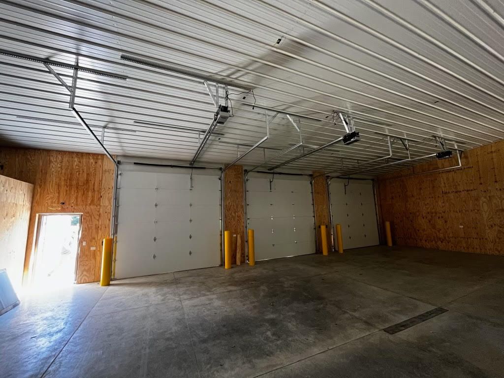 A large empty garage with a lot of garage doors.