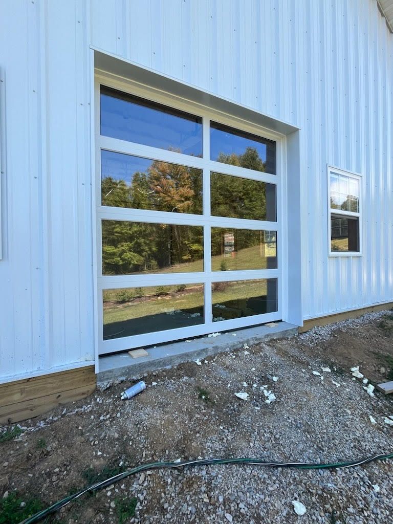 A white building with a garage door and a window.