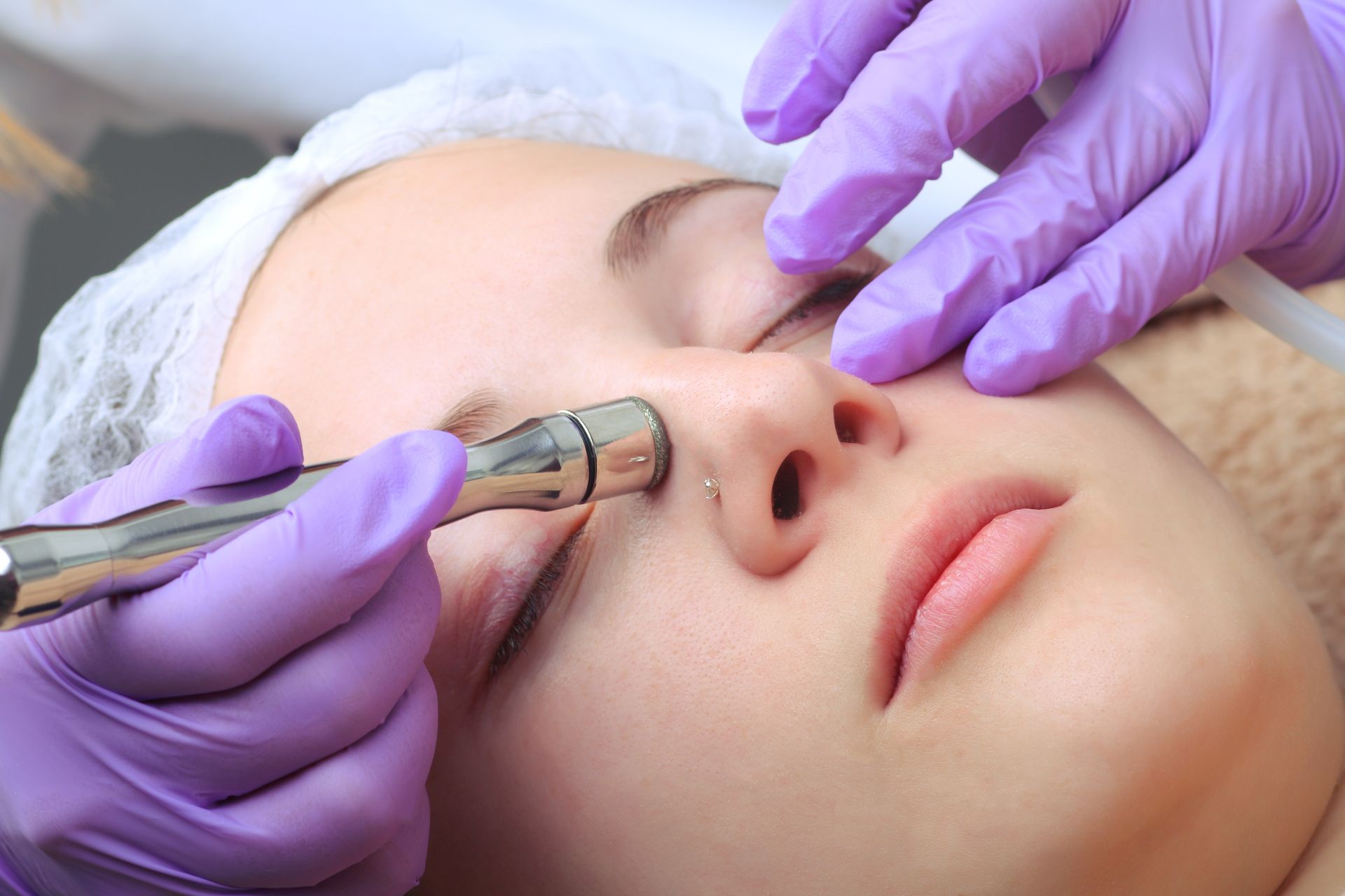 A Woman Is Getting A Facial Treatment At A Beauty Salon