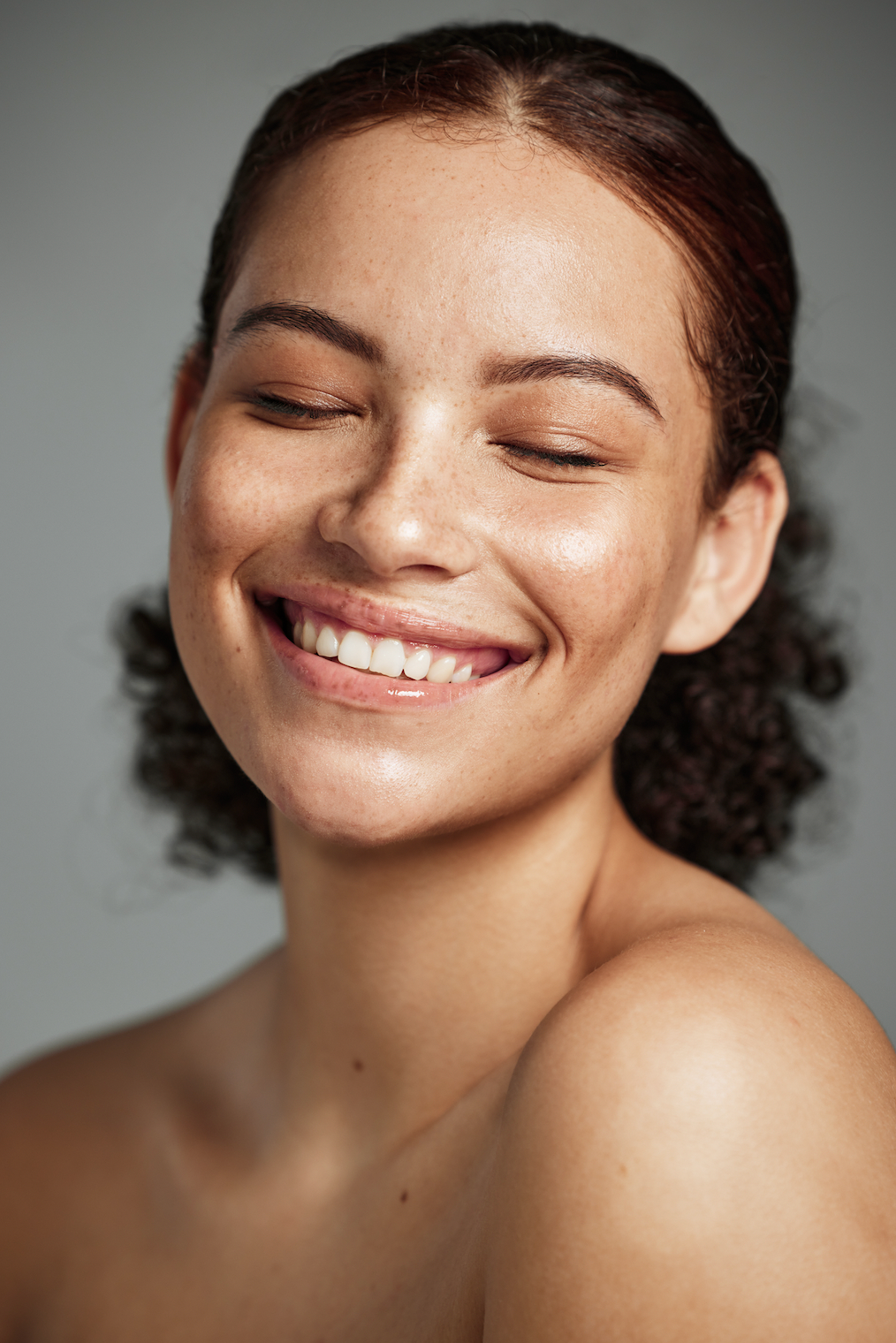 A Close Up Of A Woman Smiling With Her Eyes Closed