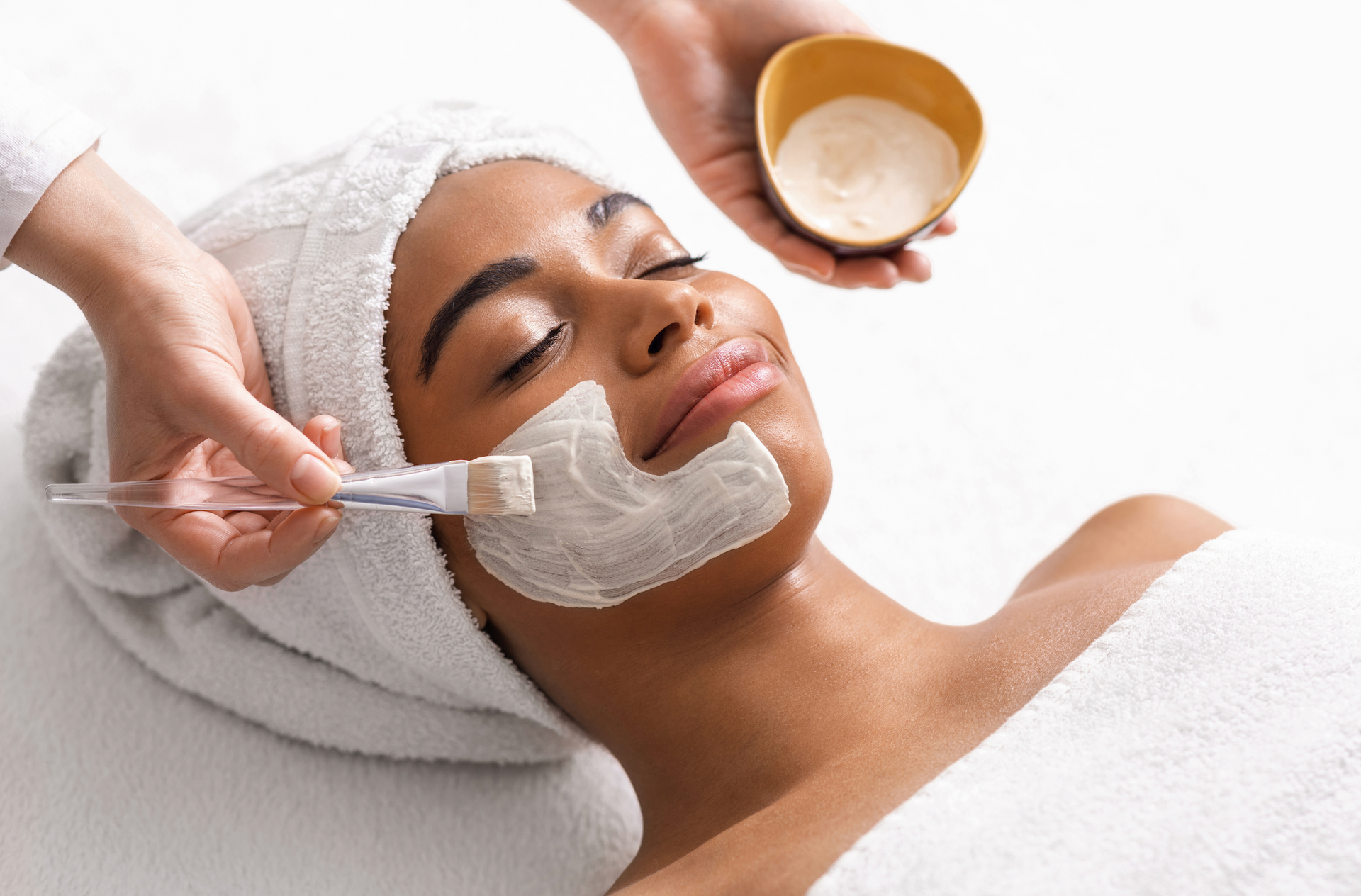 A Woman Is Getting A Facial Treatment At A Spa