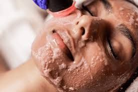 A Woman Is Getting A Facial Treatment At A Spa