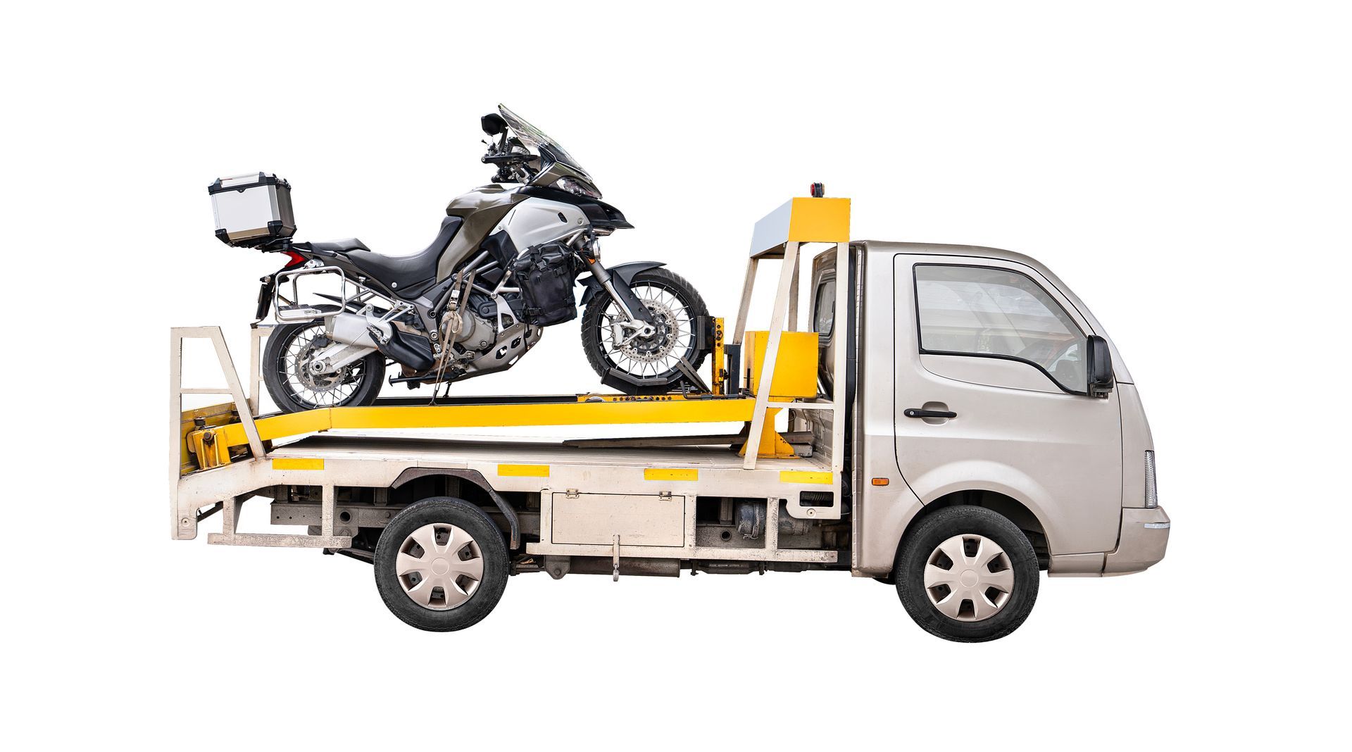 A silver motorcycle is being transported on the flatbed of a silver tow truck against a white background.